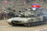 North Korean leader Kim Jong Un drives a new-type tank in North Korea