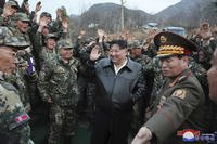 North Korean leader Kim Jong Un, center, is surrounded by soldiers