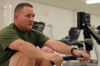 Gunnery Sgt. Chad Trebil, the 2nd Marine Division (Forward) intelligence section operations chief, uses a rowing machine aboard Camp Leatherneck, Helmand Province, Afghanistan.