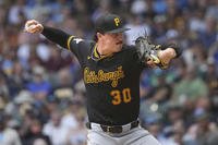 Pittsburgh Pirates pitcher Paul Skenes, who played 2 seasons of college baseball for the Air Force Academy, throws during the 4th inning of a baseball game against the Brewers in Milwaukee.