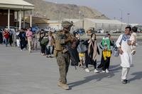 U.S. Marines escort evacuees at Hamid Karzai International Airport in Kabul