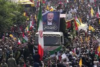 Iranians follow a truck carrying the coffins of Hamas leader Ismail Haniyeh and his bodyguard