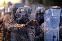 Georgia National Guard troops prepare to enforce a 9:00 pm curfew as demonstrators chant