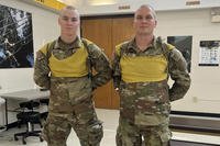 Pfc. Brayden Sumare (left) and his biological father, Pfc. William Reeves (right), pose for a photo