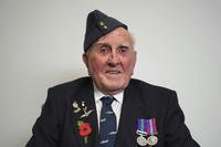 A British 100-year-old World War II veteran poses for a photograph.