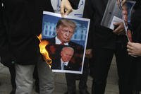 Protesters in Iran burn pictures of Donald Trump and Joe Biden