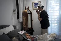 Varda Ben Baruch gestures to a Torah scroll in his bedroom.