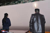 North Korean leader Kim Jong Un, right, and his daughter observe what it says is a test launch of new intercontinental ballistic missile