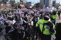 Supporters of impeached South Korean President Yoon Suk Yeol stage a rally after hearing news that a court issued warrants to detain Yoon