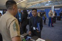 Gunnery Sgt. Nicholas Haro, a cyberspace exploitation operator with Marine Forces Cyber Command, discusses career possibilities with Tanoy Sarkar, a senior at City College of New York, during the Society of Asian Scientists and Engineers (SASE) National Conference career fair in Pittsburgh.