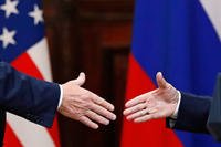 U.S. President Donald Trump shakes hands with Russian President Vladimir Putin