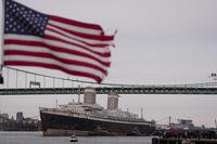 The SS United States is towed down the Delaware River between Pennsylvania and New Jersey, from Philadelphia