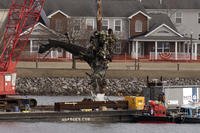 Salvage crews pull up a part of a Black Hawk helicopter near the site.