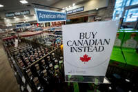 A sign is placed in front of the American whiskey section at a B.C. liquor store
