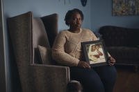 Sharline Volcy holds a  picture of her and her deceased husband, Roland Donat