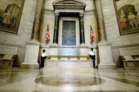 Guards stand next to the U.S. Constitution in the newly renovated Rotunda of the National Archives