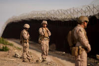 U.S. Marines install barbed wire along the border fence in San Diego