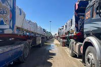Trucks line up at the Egyptian side of the border between Egypt and the Gaza Strip.