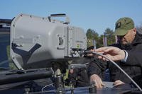 Serbian Gendarmerie officers show the U.S.-made Long Range Acoustic Device (LRAD)