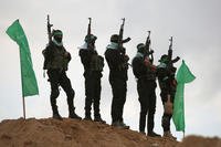 Palestinian Hamas militants gather at the site of the handing over of the bodies of 4 Israeli hostages in Khan Yunis in southern Gaza.