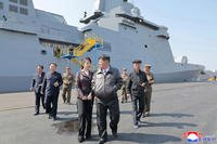 North Korean leader Kim Jong Un, front right, and his daughter visit to observe the test-firings