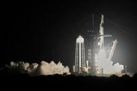 A SpaceX Falcon 9 rocket with a commercial crew of four lifts off from pad 39A at the Kennedy Space Center