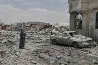 Yemeni soldier inspects the damage reportedly caused by U.S. airstrikes in Yemen
