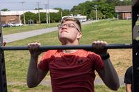A U.S. Marine with Fleet Marine Force, Atlantic, Marine Forces Command, Marine Forces Northern Command, performs a pull-up during the Murph Challenge at Camp Elmore, Norfolk, Virginia.