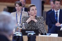 Denmark's Prime Minister Mette Frederiksen listens