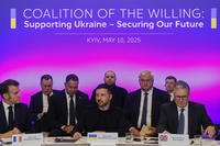France's President Emmanuel Macron, Ukrainian President Volodymyr Zelenskyy and British Prime Minister Keir Starmer sit at a table.