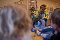 Child tests her brushing techniques on a stuffed animal