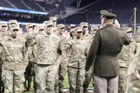 U.S. Army Gen. Andrew Poppas, commander of the U.S. Army Forces Command, performs the oath of enlistment for Army Reserve soldiers assigned to various units in the Chicagoland area before a Chicago Bears Salute to Service game at Soldier Field.