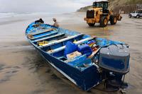 Suspected smuggling panga that overturned in the surf in Del Mar