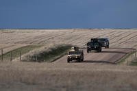 Humvees filled with security forces defenders from the 90th Security Forces Group drive down a gravel road toward one of the 90th Missile Wing’s launch facilities in the F.E. Warren Air Force Base, Wyo., Missile Complex.