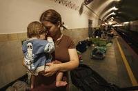 Oleksandra Umanets, 23, calms her 10-month-old son as they take cover on the platform of a metro station during a Russian attack on Kyiv