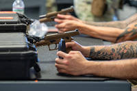 Combat Arms Training and Maintenance students learn how to properly handle M18 pistols at Holloman Air Force Base, New Mexico.