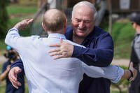 Russian President Vladimir Putin, front, embraces Belarusian President Alexander Lukashenko
