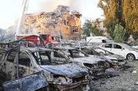 Firefighters work on the site of a burning building after a Russian attack in Kyiv, Ukraine