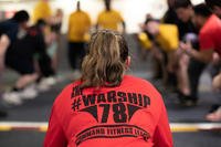 A retail services specialist 3rd class, assigned to the USS Gerald R. Ford’s (CVN 78) supply department, conducts a command fitness class in the hangar bay.