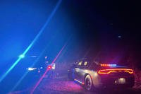 In this photo provided by the Thurston County Sheriff's Office, law enforcement personnel respond to a Wednesday evening, Sept. 17, 2025, helicopter crash near Joint Base Lewis-McChord in Washington state.