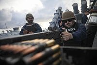 Navy Petty Officer 1st Class Brandon House fires a .50-caliber machine gun