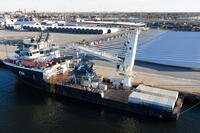 Wind turbine bases, generators and blades are positioned at The Portsmouth Marine terminal along with a support ship at the staging area for Dominion Energy's wind turbine project Monday Dec. 22, 2025, in Portsmouth, Va. (AP Photo/Steve Helber)