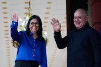 Venezuela's acting President Delcy Rodriguez and Interior Minister Diosdado Cabello, right, wave before making a statement at Miraflores presidential palace in Caracas, Venezuela, Wednesday, Jan. 14, 2026. (AP Photo/Ariana Cubillos)