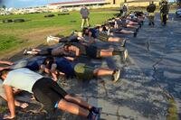 Navy special operations candidates do pushups.