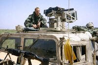 Then-Marine Recon team leader Brad Colbert rides in a Humvee during the early days of the Iraq invasion in 2003. Photo credit: Evan Wright.
