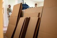 Unfolded brown cardboard boxes.