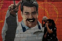 Pedestrians walk past a mural depicting former Venezuelan President Nicolas Maduro in Caracas, Venezuela, Saturday, Jan. 10, 2026, a week after U.S. forces captured him. (AP Photo/Matias Delacroix)
