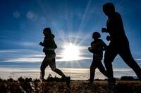 Silhouettes running at sunrise.