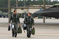 Maj. David Pifferario, 302nd Fighter Squadron F-22 pilot, and Capt. Ryan Pelkola, a 90th FS pilot, step to their Raptors. (U.S. Air Force/Scott Wolfe)