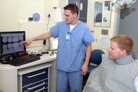 Dentist shows patient xray